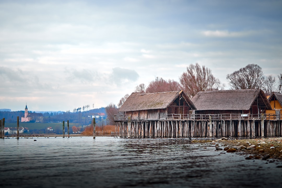 Stilt houses on a lake with distant church