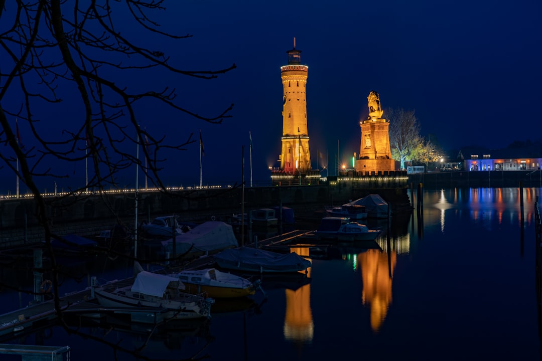 a body of water at night with a clock tower in the background