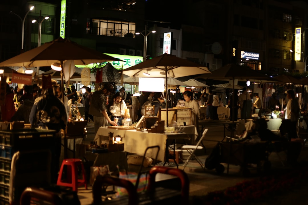 People browsing stalls at a bustling night market.