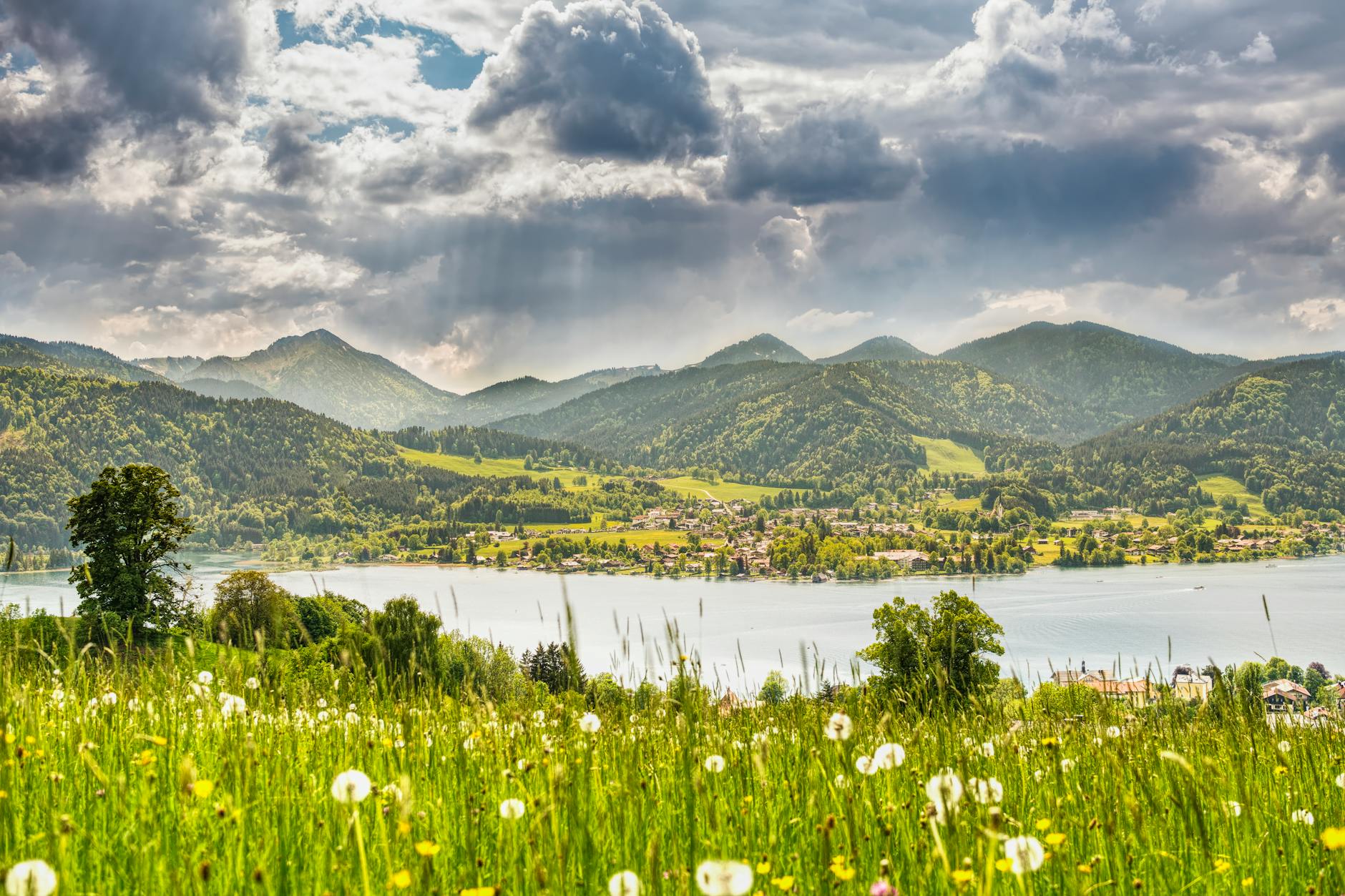 Breathtaking panorama of Tegernsee Lake surrounded by the lush Bavarian Alps in summer.