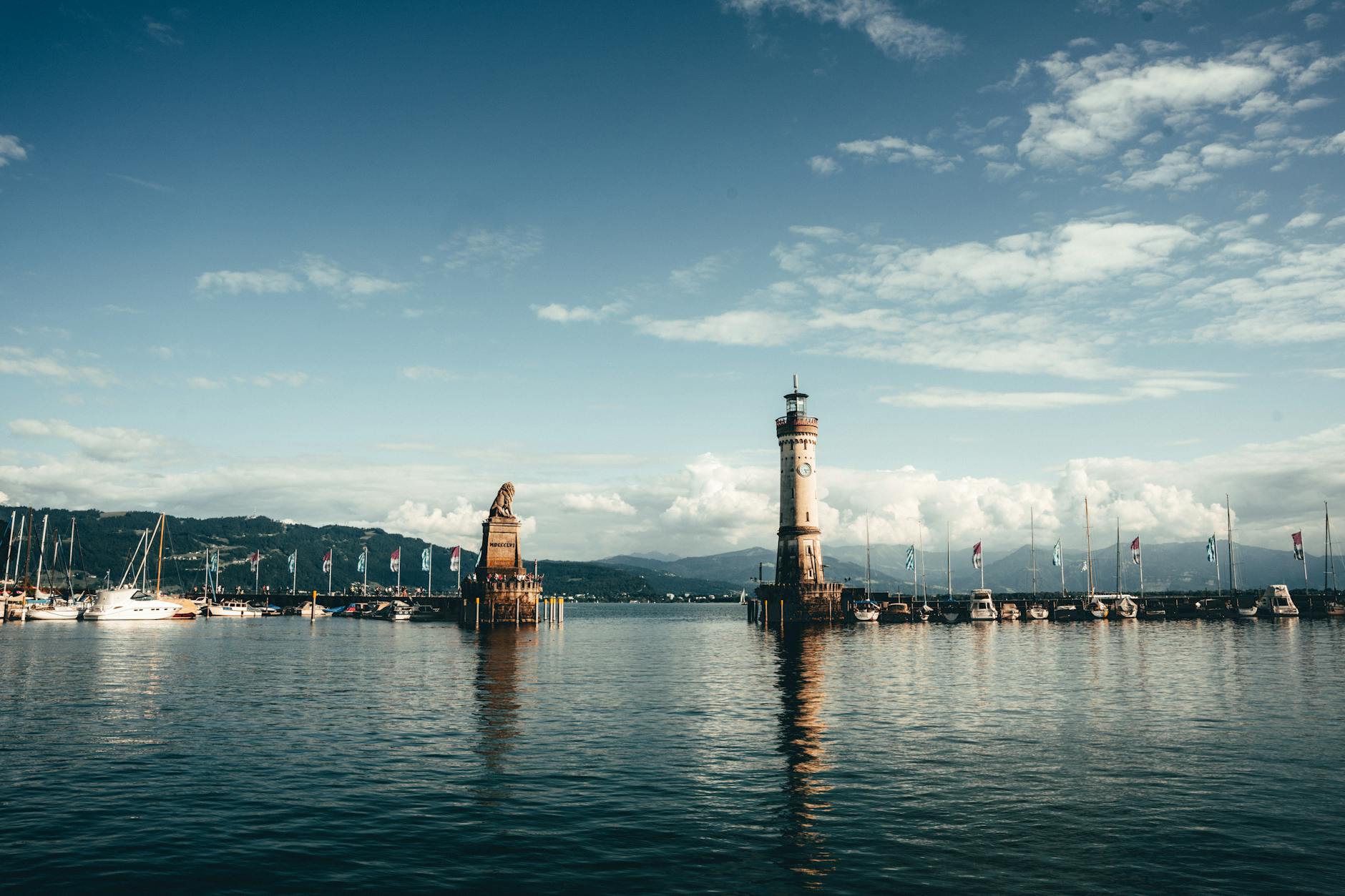 Beautiful landscape of Lindau Harbor featuring the iconic lighthouse and lion statue at Lake Constance.