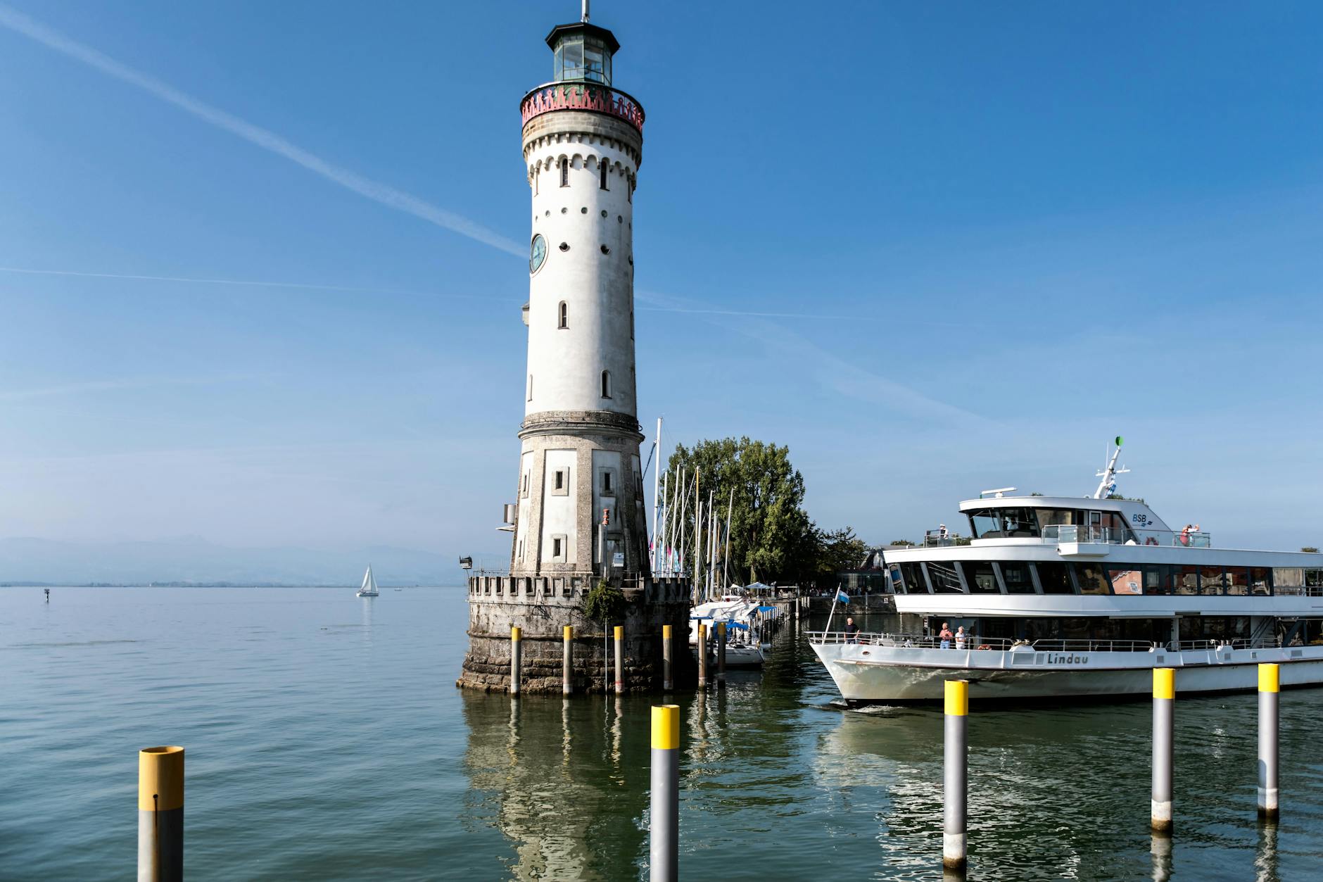 Beautiful view of Lindau Lighthouse and ship on Lake Constance, Germany.