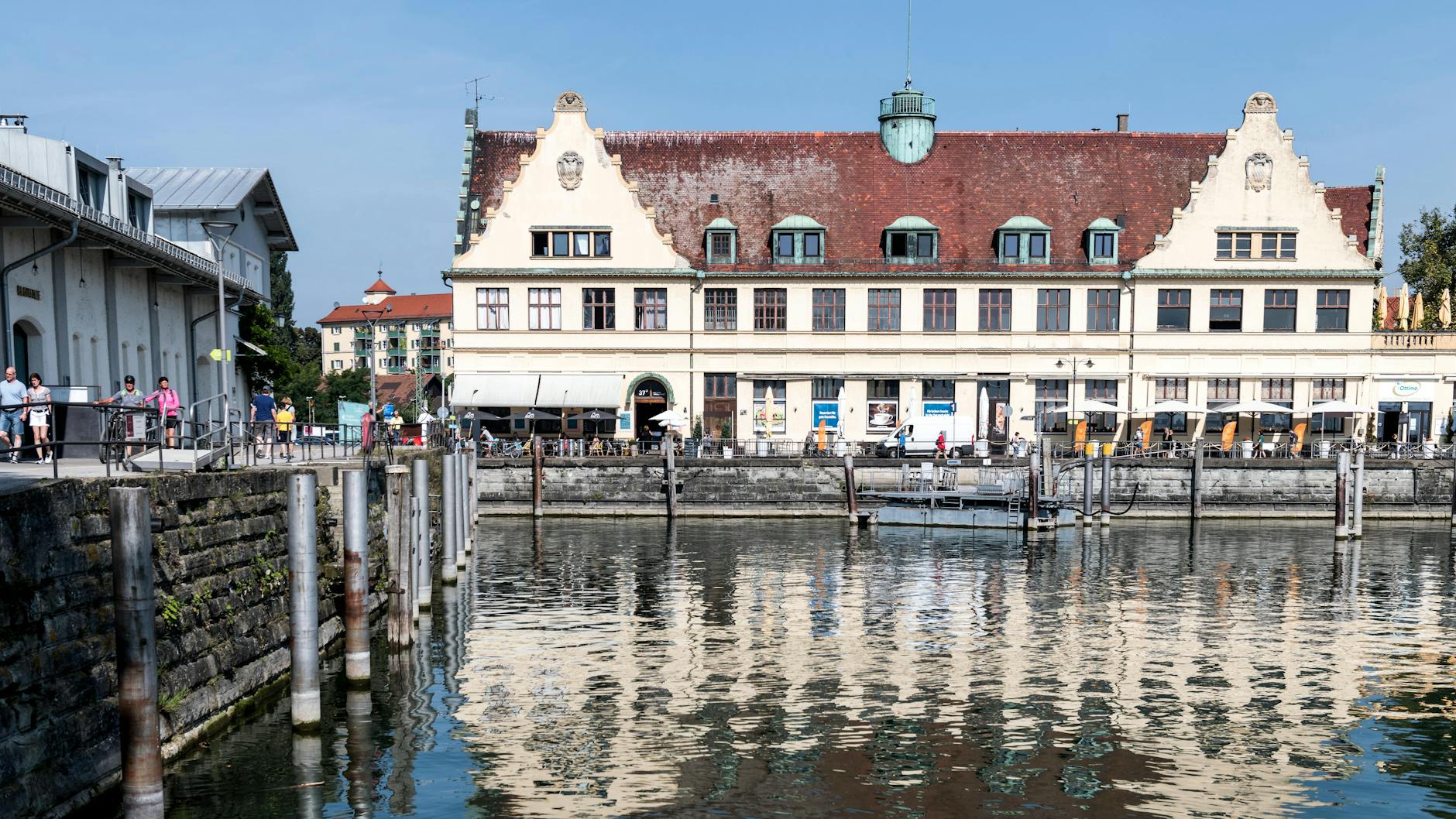 Picturesque waterfront with historic buildings in Lindau, Germany, reflecting on Lake Constance.