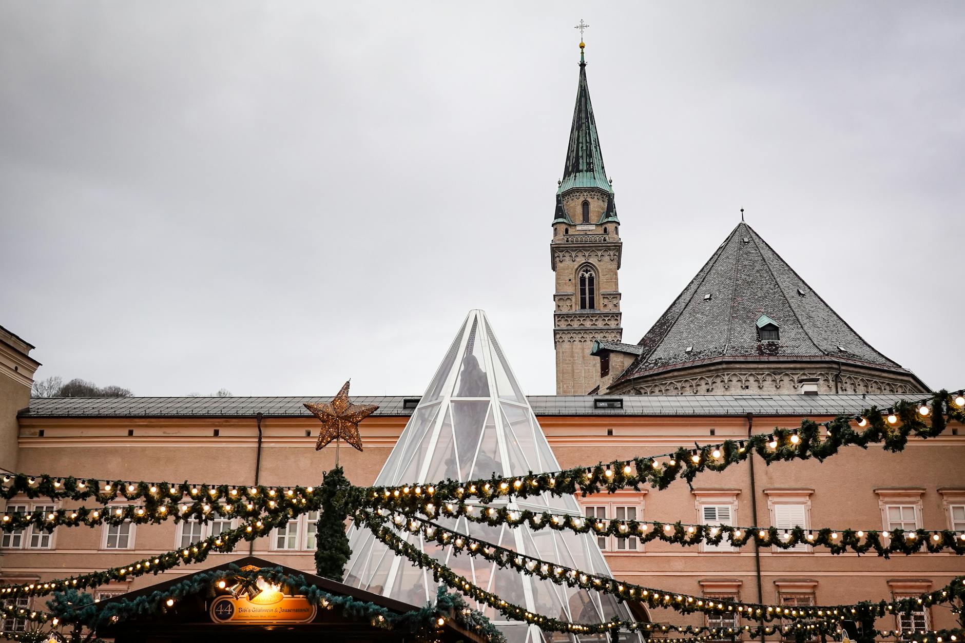 Embrace holiday spirit at a charming Christmas market with historic buildings and festive lights.