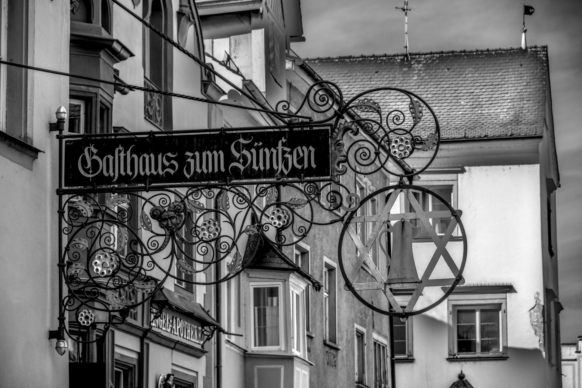 Black and white photo of "Gasthaus zum Sünfzen" signboard in Lindau, Germany.