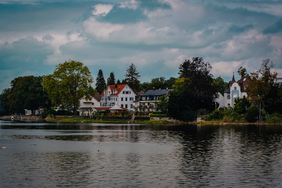 A body of water with houses in the background