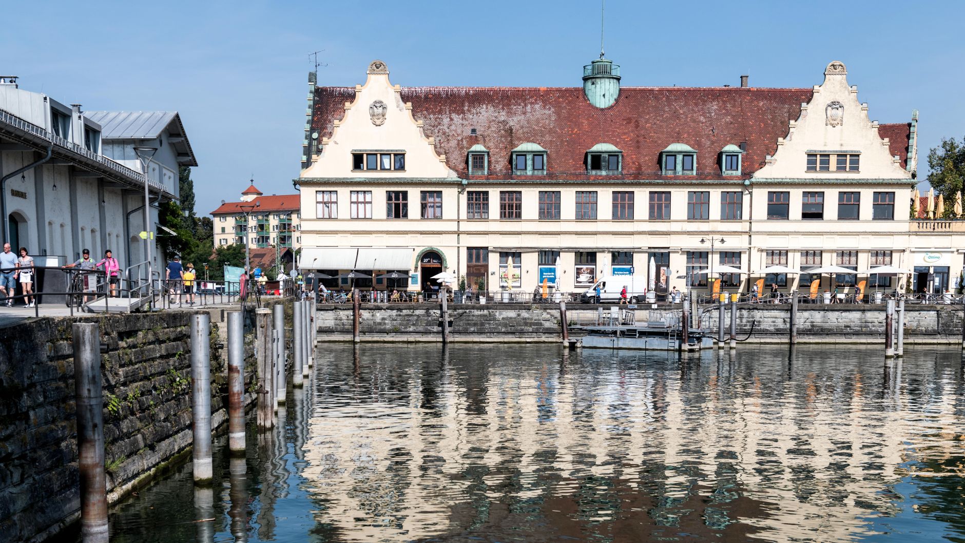 Picturesque waterfront with historic buildings in Lindau, Germany, reflecting on Lake Constance.